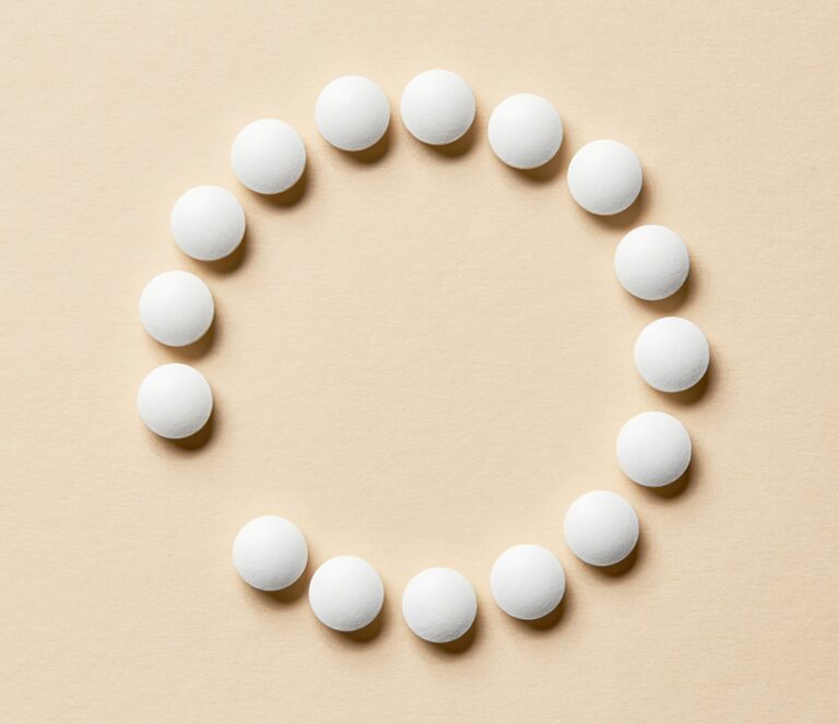 white pills on beige background