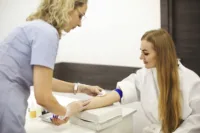 Nurse preparing patient for blood draw